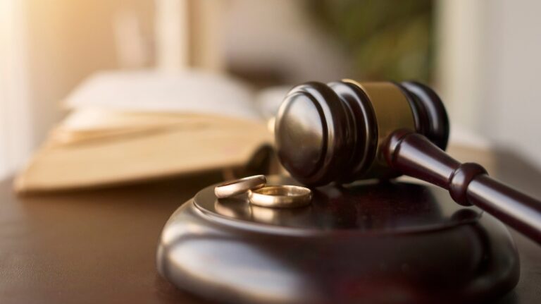 Judge gavel and wedding rings for divorce proceedings