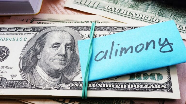 Pile of dollars with word alimony on a stick