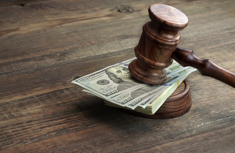 judge's gavel and a wad of dollars