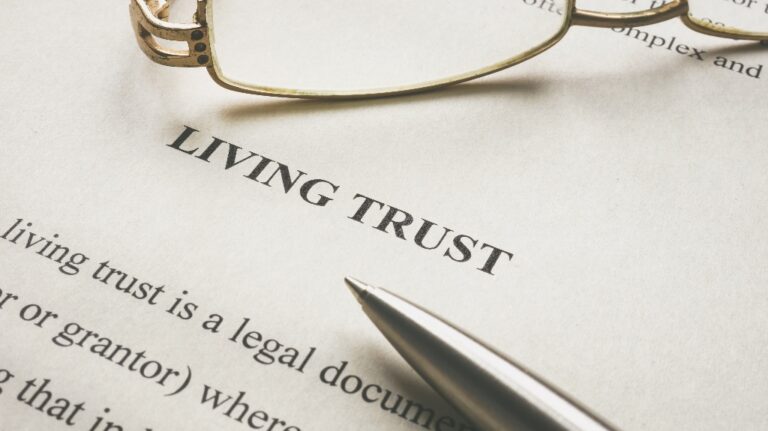 Document about Living trust and glasses on it