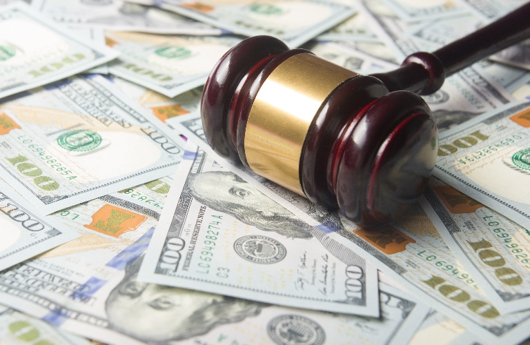 Judge's gavel on the dollar cash background