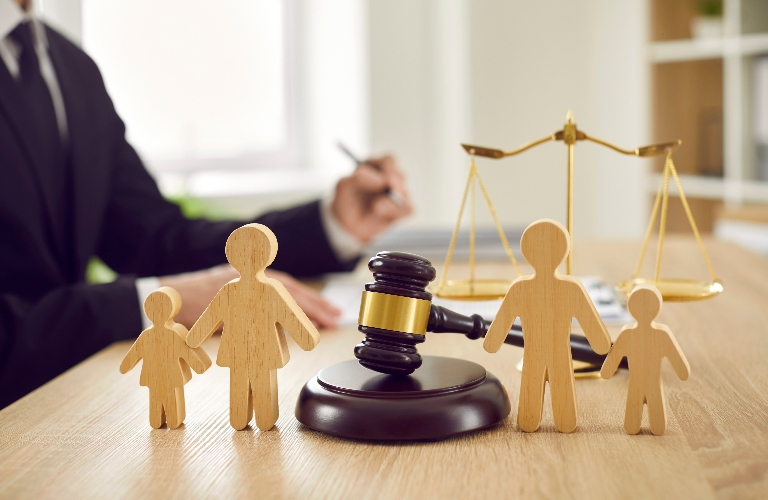wooden family figures and judge's gavel