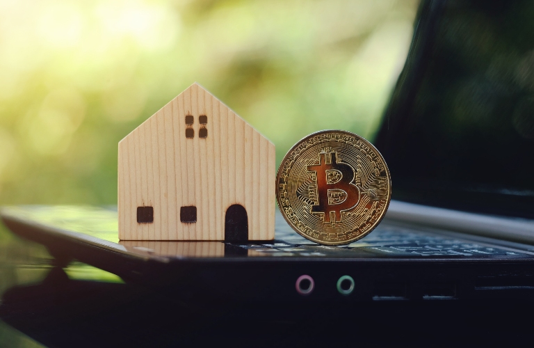 bitcoin and toy wooden house